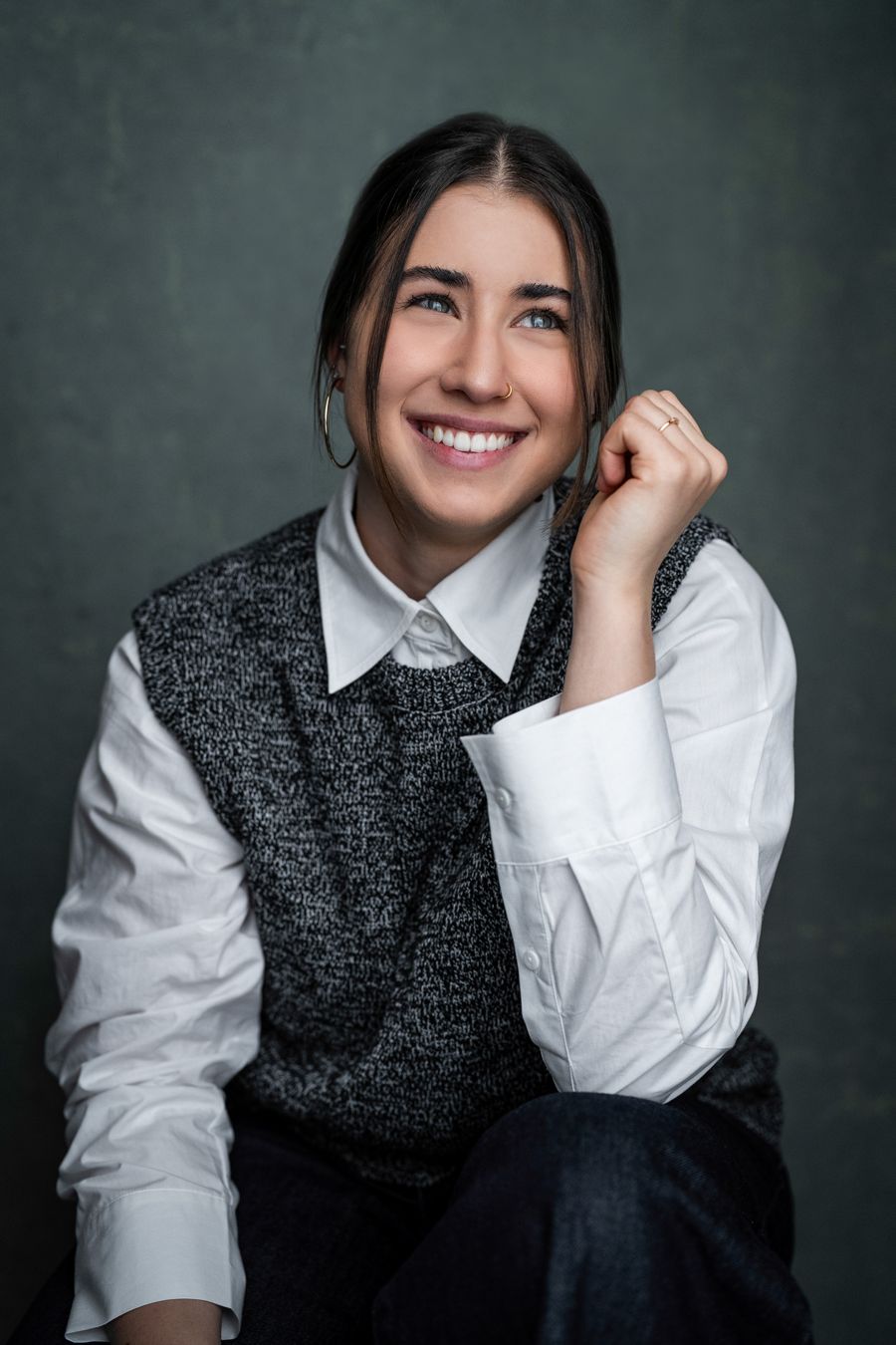 Emiliya Sivankova smiling, wearing a white shirt and grey knitted vest